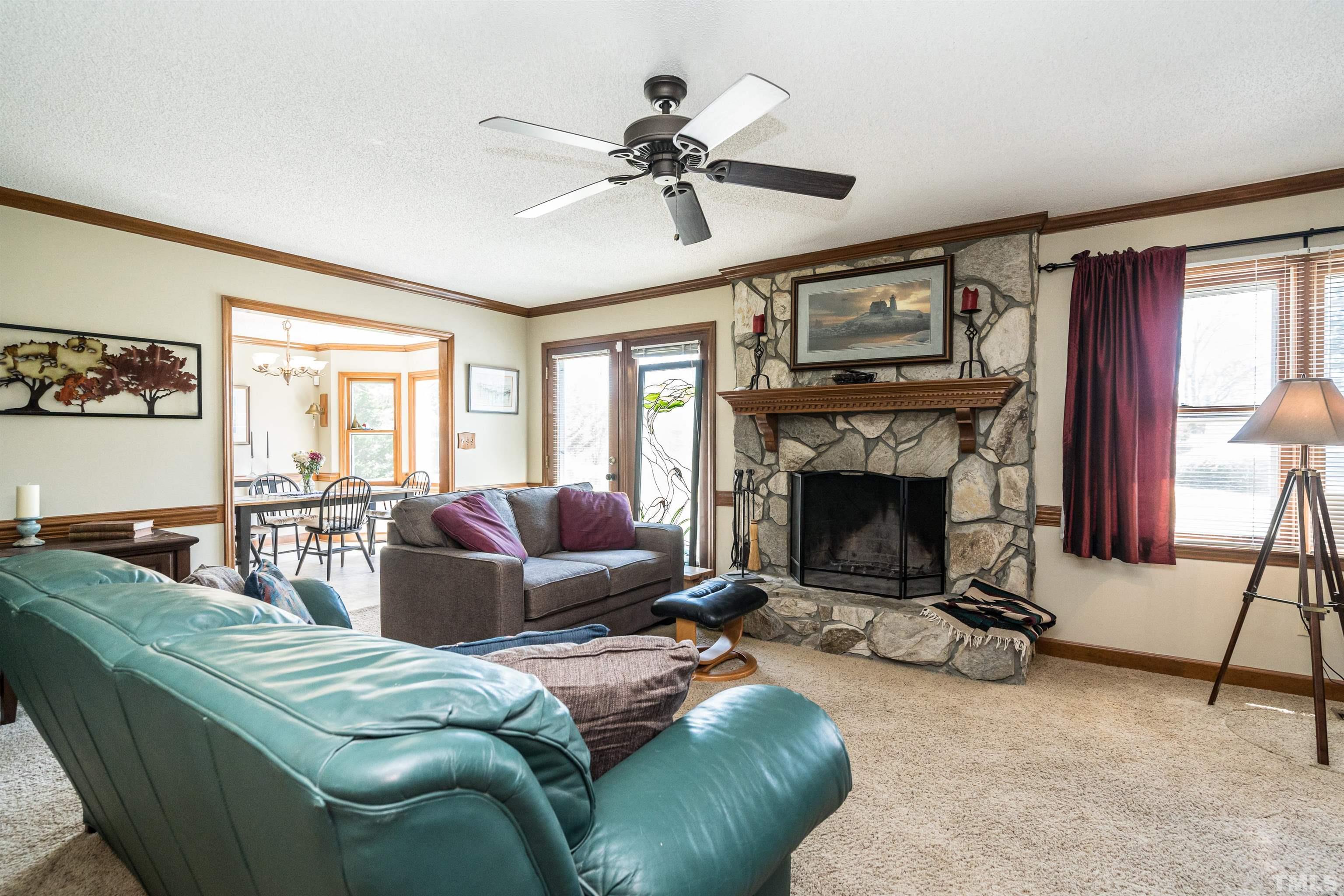 5929 Hampton Ridge Road Raleigh, NC 27603 - Photo 8 of 27 a living room with furniture a window and a fireplace