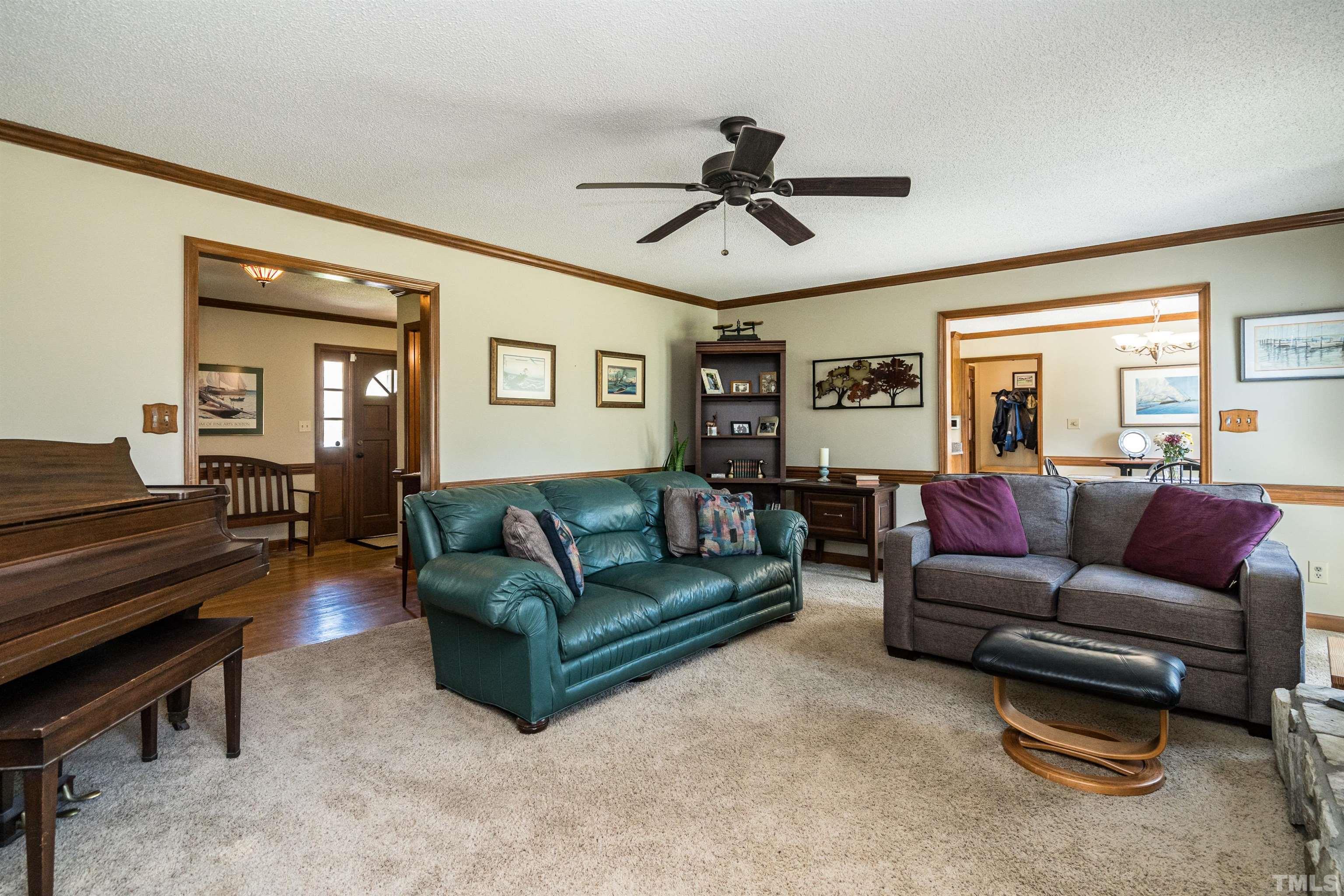 5929 Hampton Ridge Road Raleigh, NC 27603 - Photo 10 of 27 a living room with furniture a ceiling fan and a window