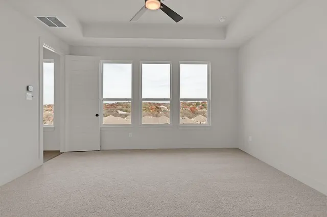 a bedroom with a bed lamp and window