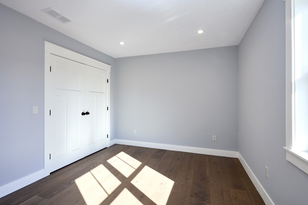 1 Thomas Drive Acton, MA 01720 - Photo 26 of 36 an empty room with wooden floor and windows