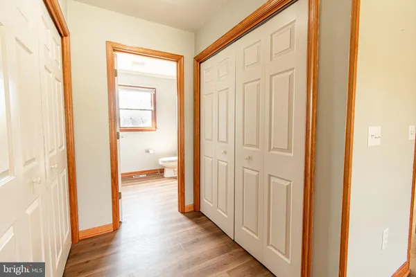 a view of a hallway with wooden floor