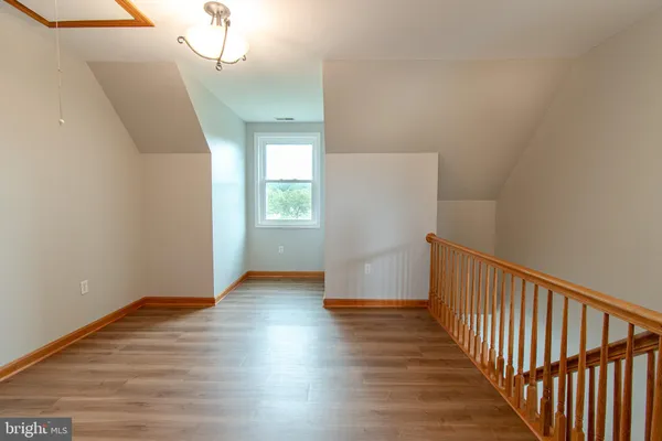 a view of a room with wooden floor and window