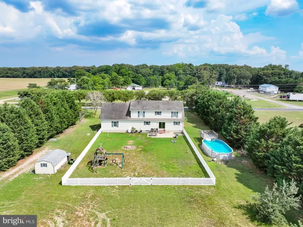 a view of a swimming pool with a yard and lake view