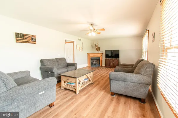 a living room with furniture and a wooden floor