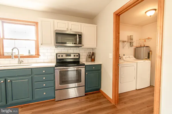 a kitchen with a stove and a microwave