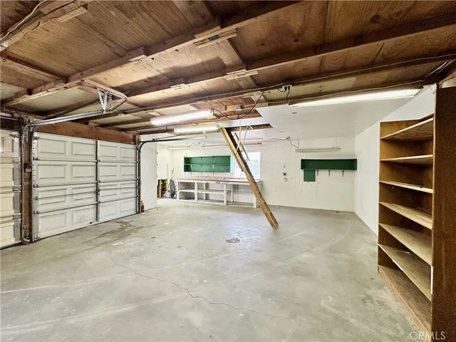 a view of a hall with wooden floor and windows