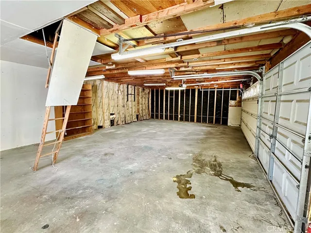 a view of a patio with chairs and potted plants