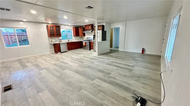 a kitchen with stainless steel appliances granite countertop a sink stove and cabinets