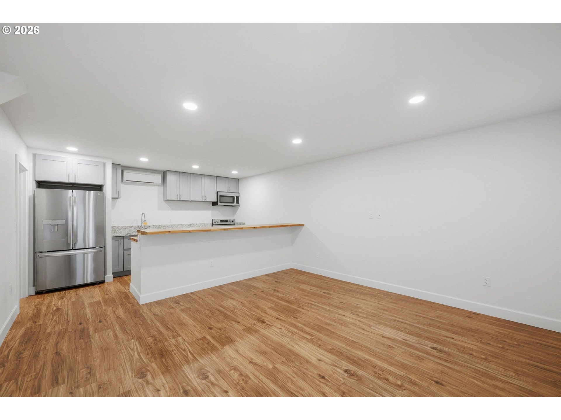 50 South 17th Street Cottage Grove, OR 97424 - Photo 6 of 24 a view of kitchen with stainless steel appliances cabinets a sink and wooden floor