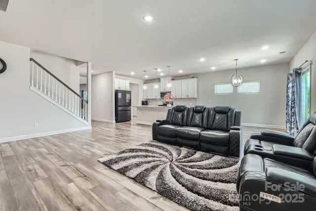 a view of a living room kitchen and a wooden floor