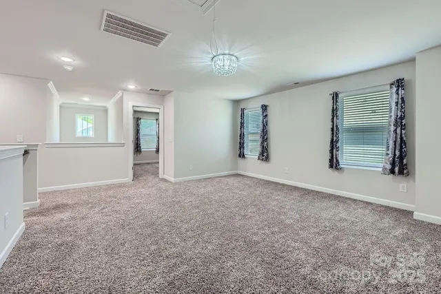 an empty room with windows and entrance