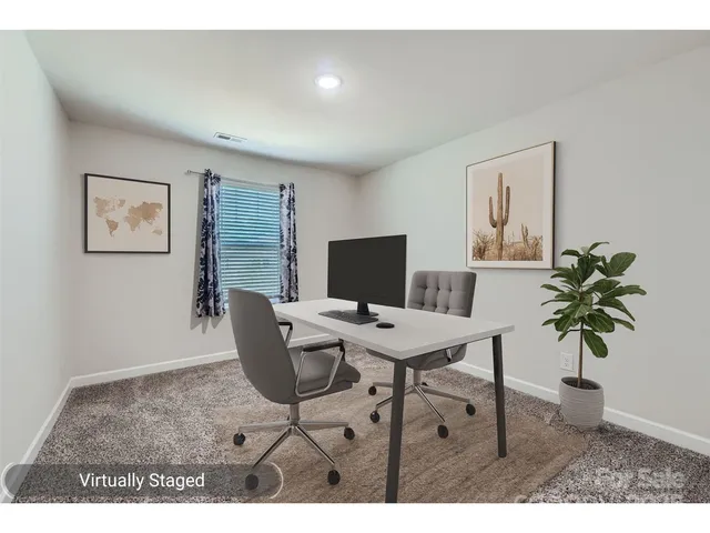 a workspace with furniture and a potted plant