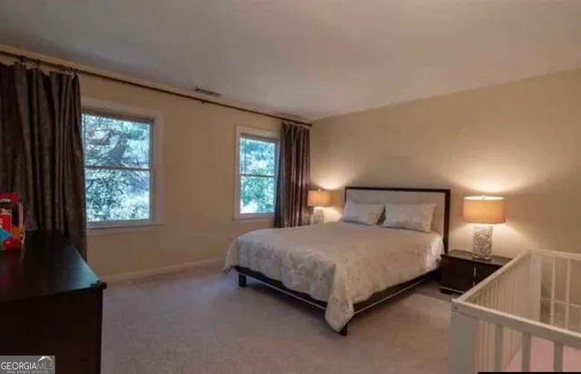 a spacious bathroom with a double vanity sink a large mirror and a bathtub
