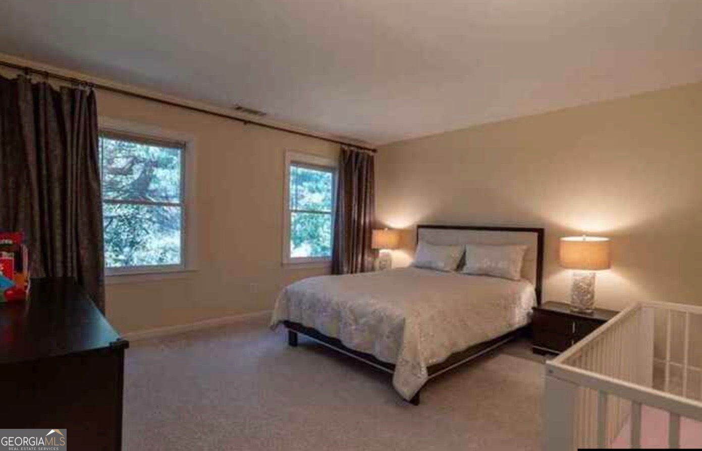 212 Abingdon Way Northeast Sandy Springs, GA 30328 - Photo 12 of 21 a bedroom with a bed and a window