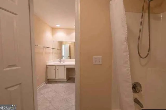 a bathroom with a glass shower door