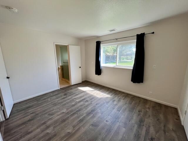 490 Foxen Lane Los Alamos, CA 93440 - Photo 8 of 16 a view of an empty room with wooden floor and a window