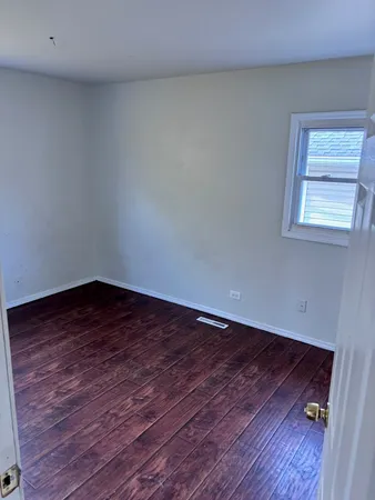 a view of an empty room and wooden floor