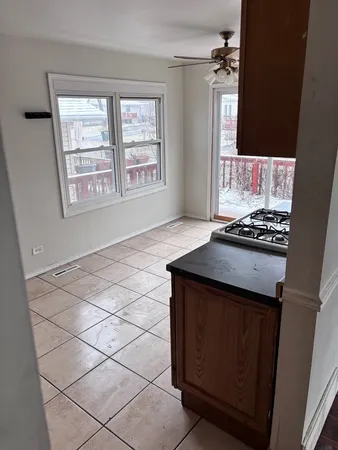 an empty room with window and cabinet