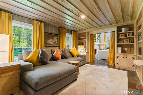 a bedroom with furniture and a large window