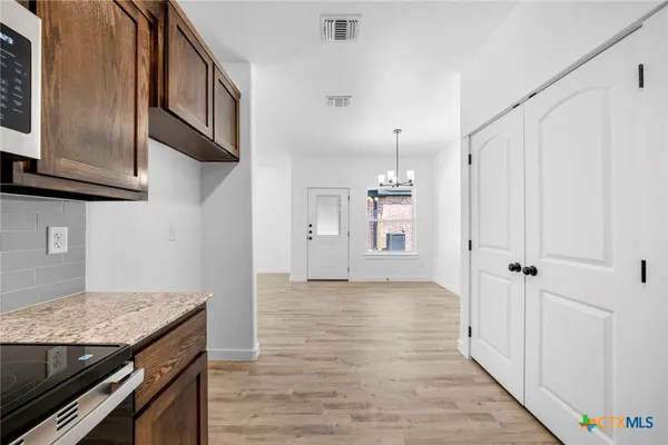 a view of a kitchen cabinets and wooden floor