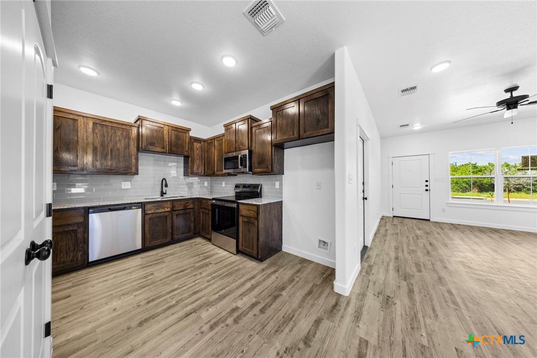 3604 Canvasback Road Killeen, TX 76542 - Photo 14 of 27 a kitchen with stainless steel appliances kitchen island granite countertop a refrigerator and a sink