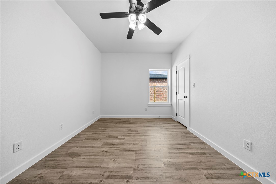 3604 Canvasback Road Killeen, TX 76542 - Photo 22 of 27 wooden floor in an empty room with a window
