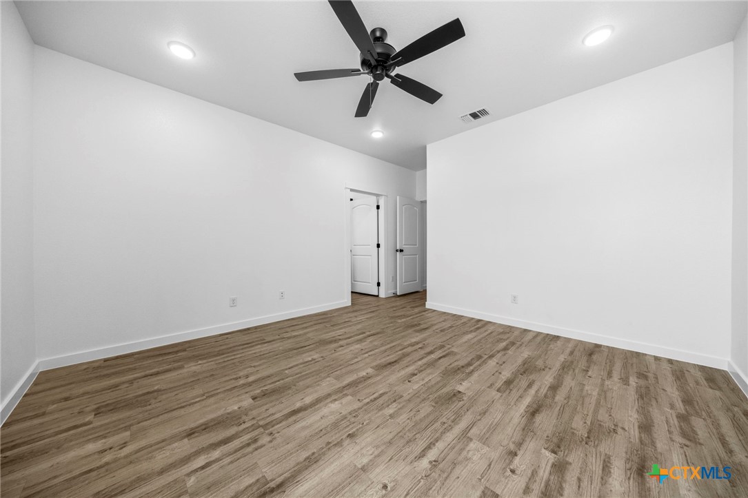 3604 Canvasback Road Killeen, TX 76542 - Photo 24 of 27 an empty room with wooden floor and ceiling fan