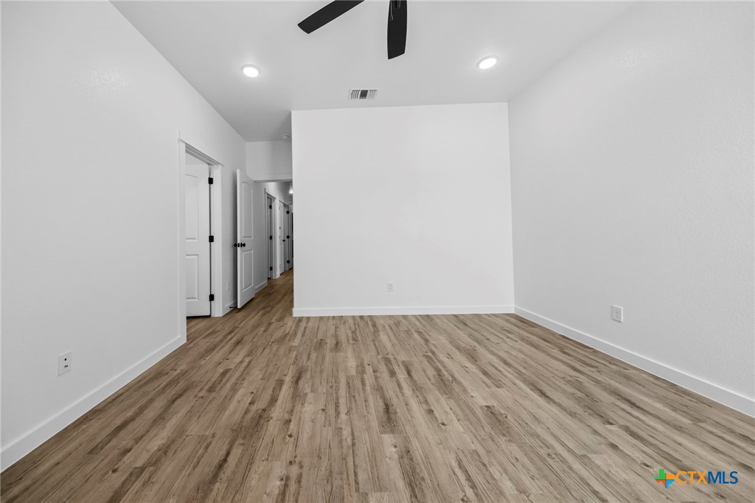 3604 Canvasback Road Killeen, TX 76542 - Photo 25 of 27 a view of a room with wooden floor staircase and a kitchen