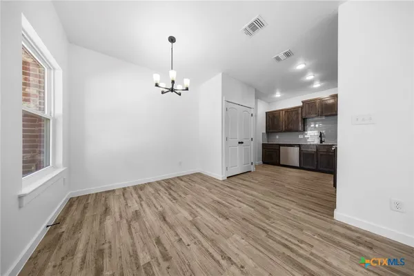 a view of a kitchen with a sink and a stove top oven