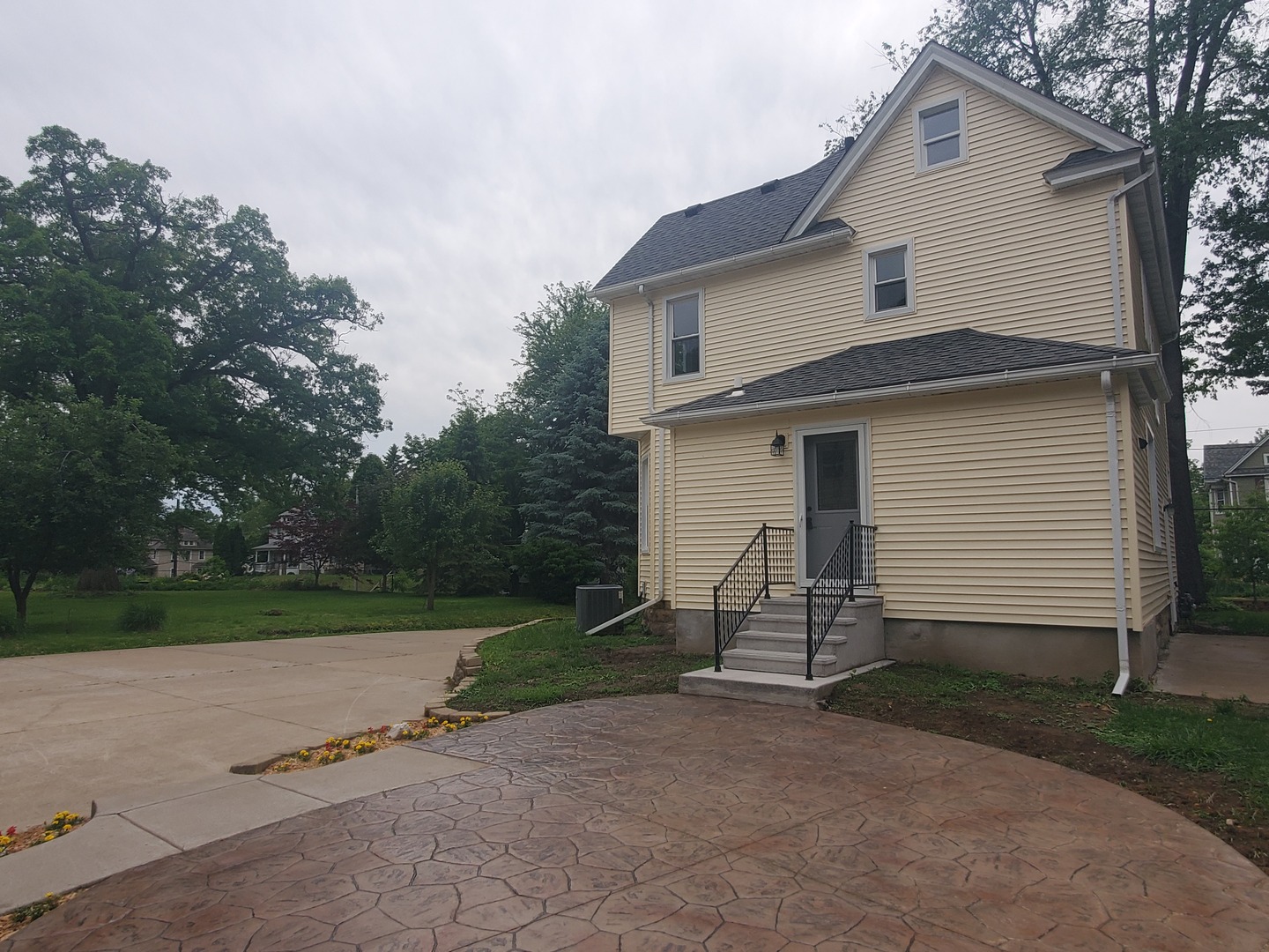 712 3rd Street Moline, IL 61265 - Photo 5 of 29 a view of a white house next to yard and road