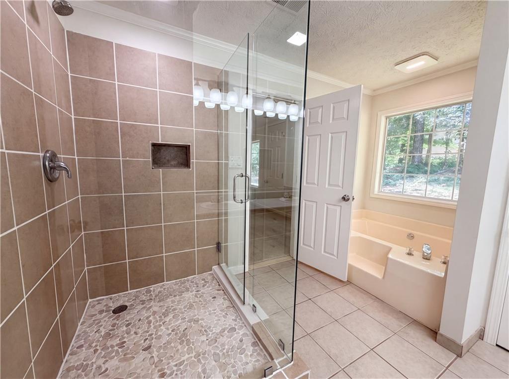 722 Ridgetop Road Bethlehem, GA 30620 - Photo 16 of 23 a bathroom with a bathtub and a shower