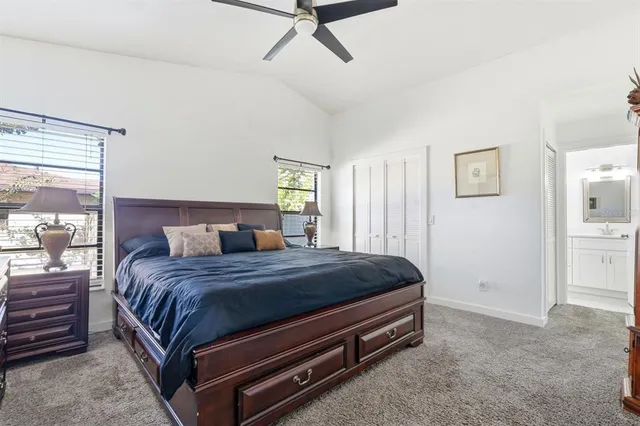a bed sitting in a bedroom chandelier and a dresser