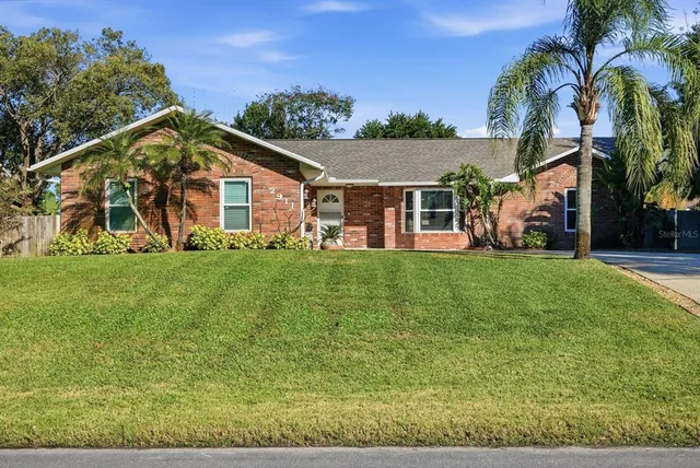 a front view of house with yard and green space