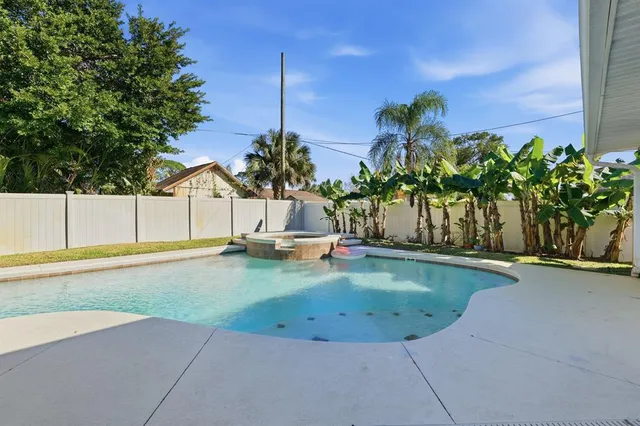 a view of a swimming pool with a yard
