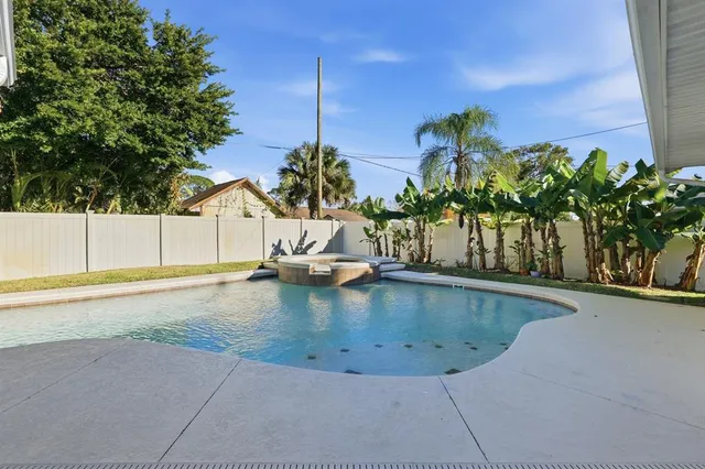 swimming pool view with a seating space