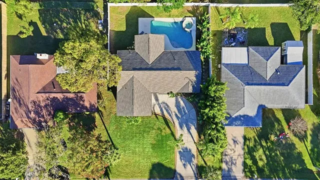 an aerial view of a house with a yard and garden