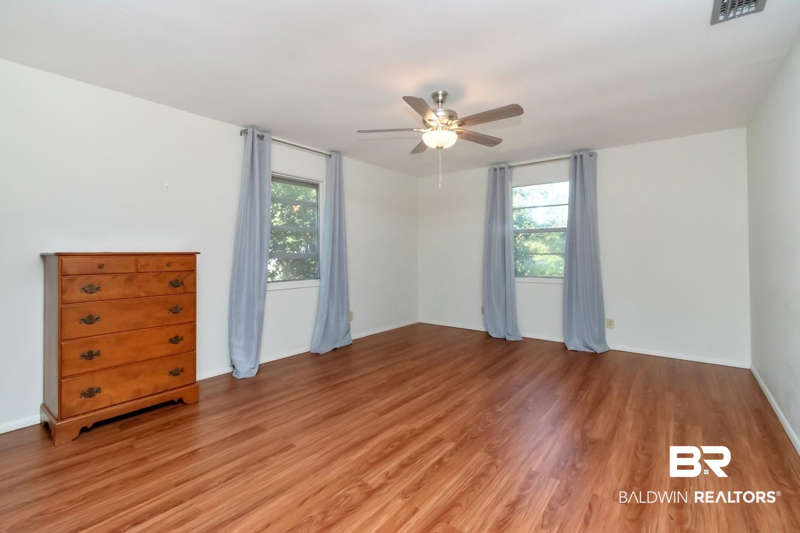 5412 South Norden Drive Mobile, AL 36608 - Photo 27 of 38 Spare room featuring ceiling fan, light hardwood / wood-style floors, and a healthy amount of sunlight