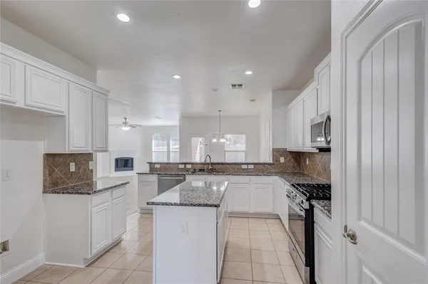 a kitchen with refrigerator and cabinets
