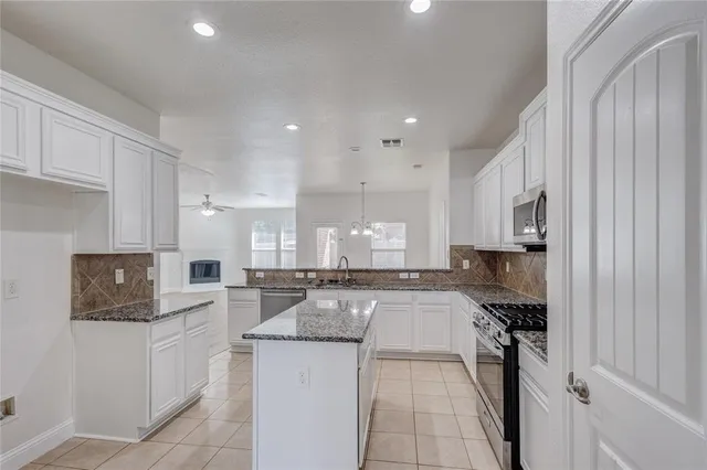 a kitchen with refrigerator and cabinets