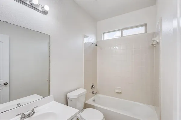 a bathroom with a toilet and a bathtub