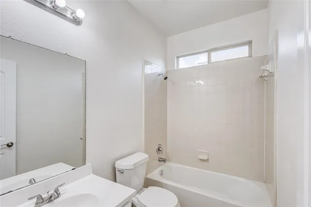 a bathroom with a toilet and a bathtub