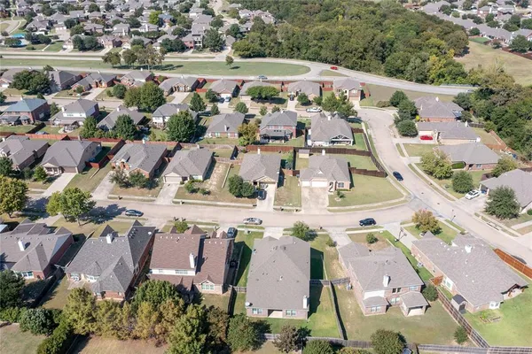 an aerial view of multiple houses with yard
