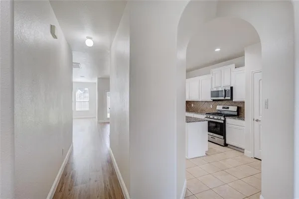 a kitchen with cabinets and stainless steel appliances