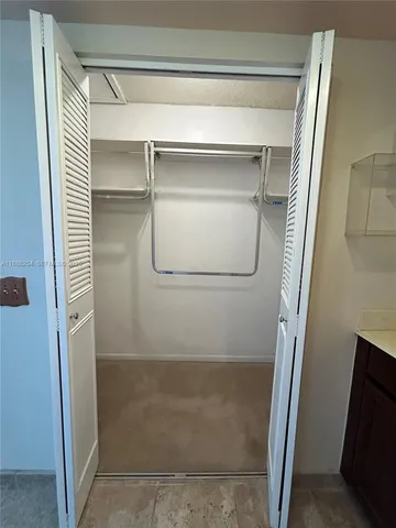 a kitchen with a sink a counter top space and cabinets