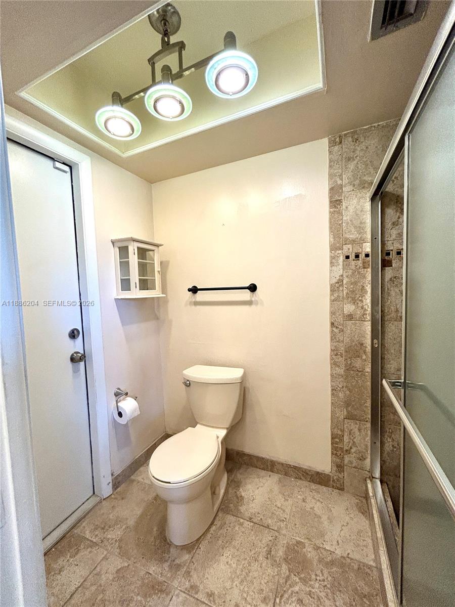 6520 Southwest 20th Street Plantation, FL 33317 - Photo 14 of 43 a bathroom with a toilet sink and a mirror