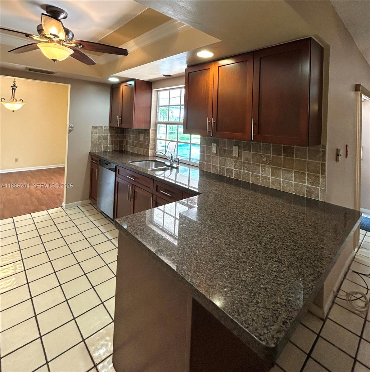 6520 Southwest 20th Street Plantation, FL 33317 - Photo 18 of 43 a kitchen with stainless steel appliances kitchen island granite countertop a sink and cabinets