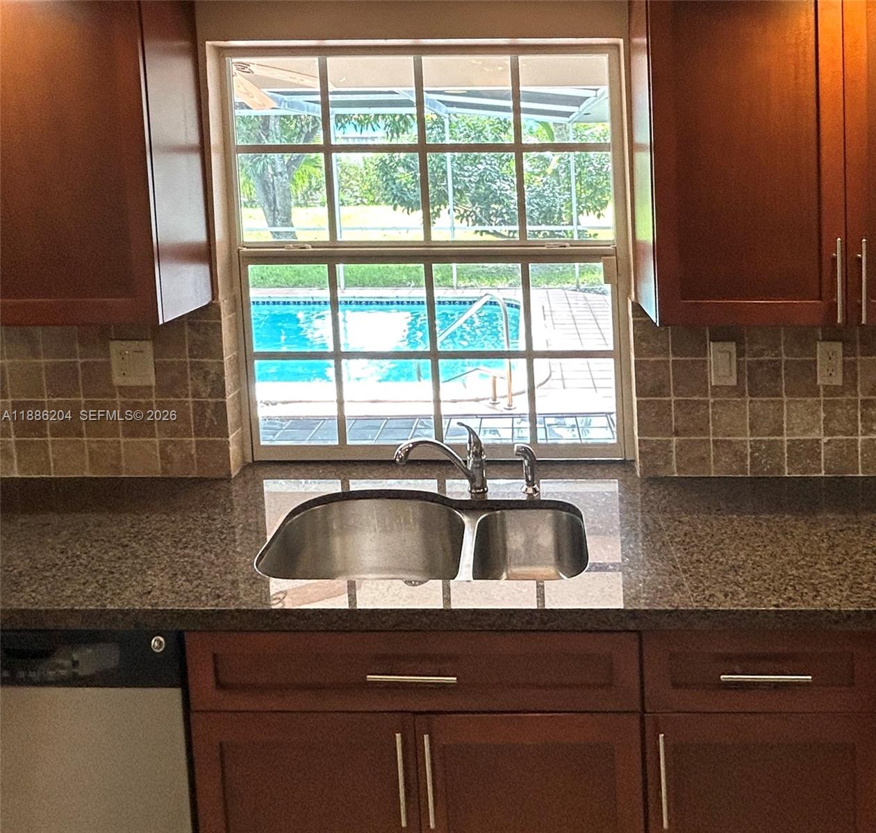 6520 Southwest 20th Street Plantation, FL 33317 - Photo 19 of 43 a kitchen with a sink a counter top space and cabinets