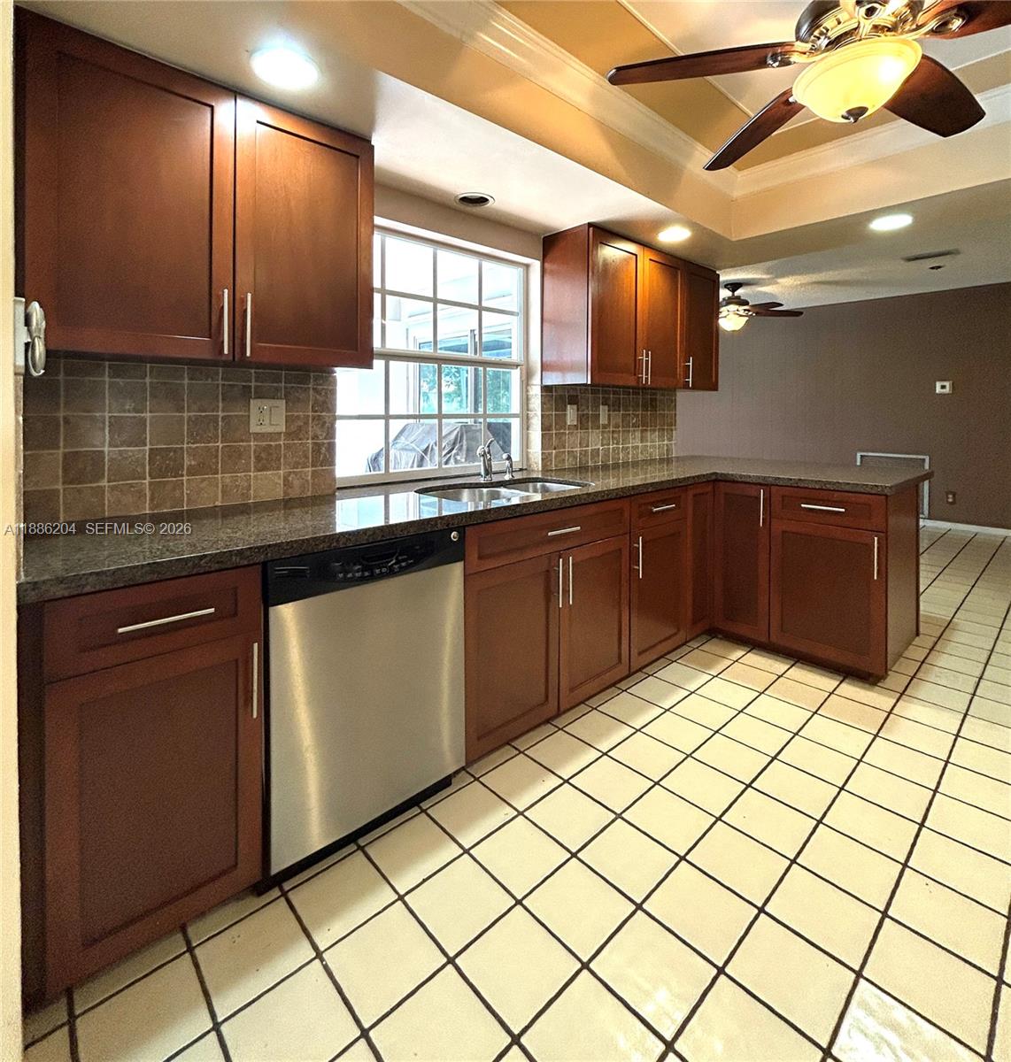 6520 Southwest 20th Street Plantation, FL 33317 - Photo 20 of 43 a kitchen with stainless steel appliances granite countertop a sink and cabinets