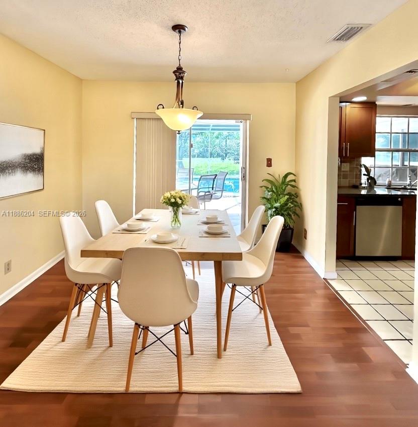 6520 Southwest 20th Street Plantation, FL 33317 - Photo 8 of 43 a view of a dining room with furniture window and wooden floor