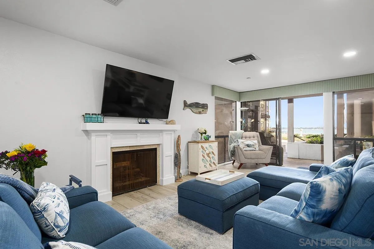 1125 Pacific Beach Drive, Unit 104 San Diego, CA 92109 - Photo 11 of 67 a living room with furniture a fireplace and a flat screen tv